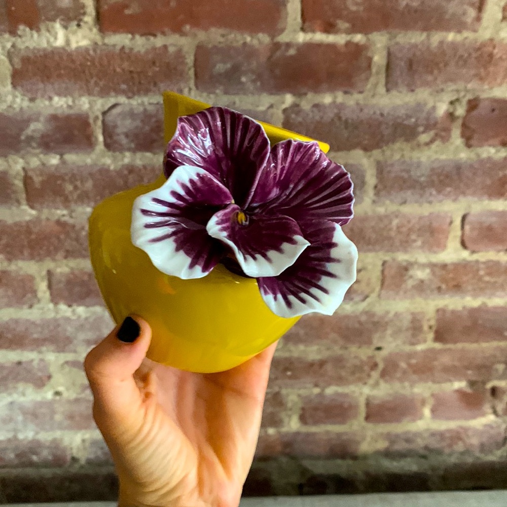 Mustard color vase with a lavender flower accent